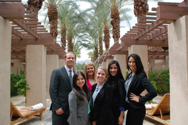 Students in business attire in outdoor hotel lounge area